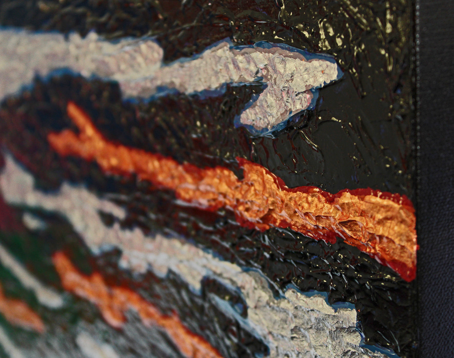 SEAM precious metals cross through a darkened background across a heavy, bold canvas.